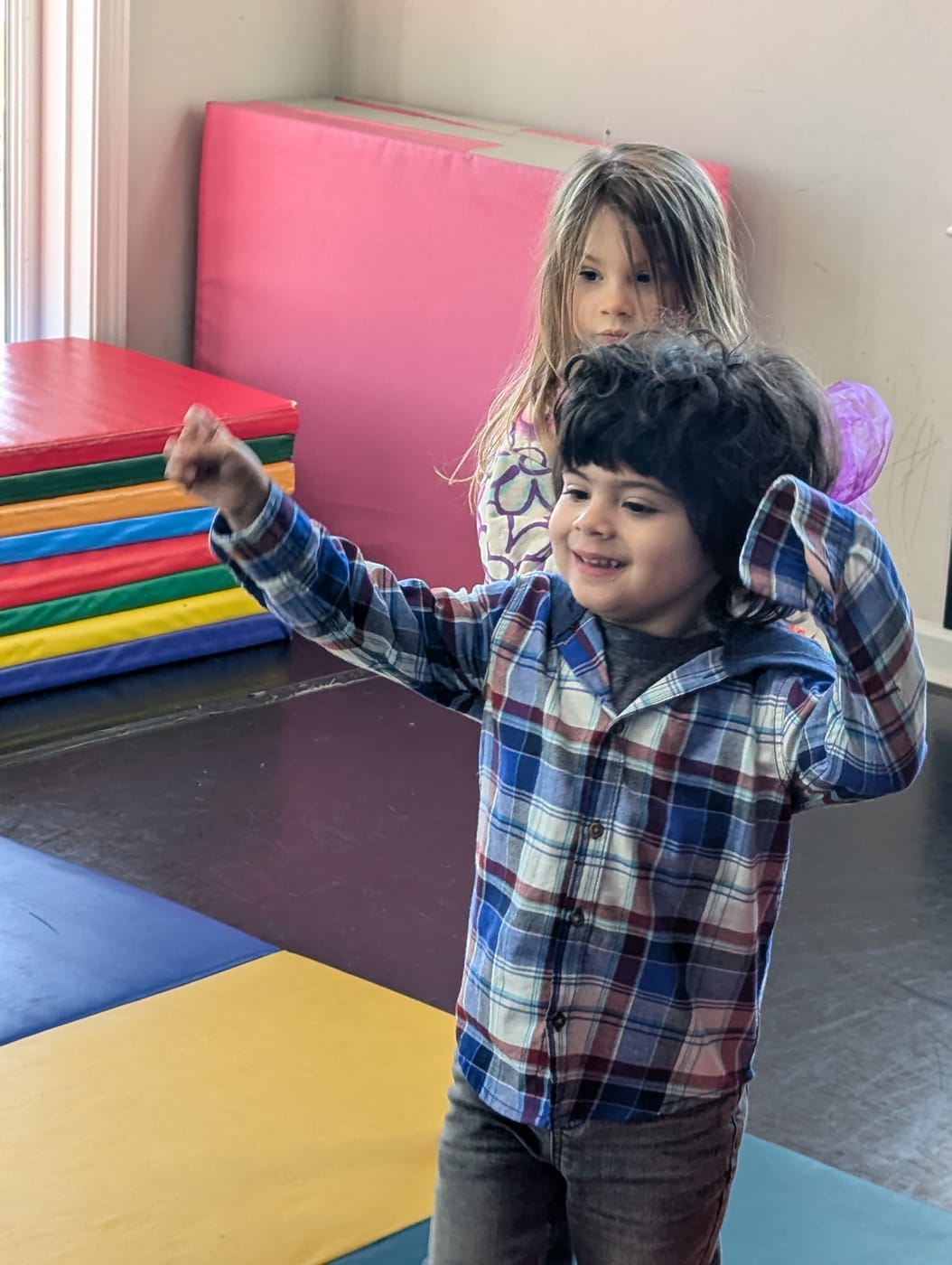 Children moving and dancing on gym mats